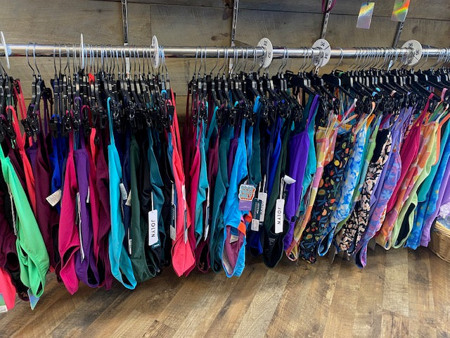 Colorful lanyards hanging on a rack with wooden wall background
